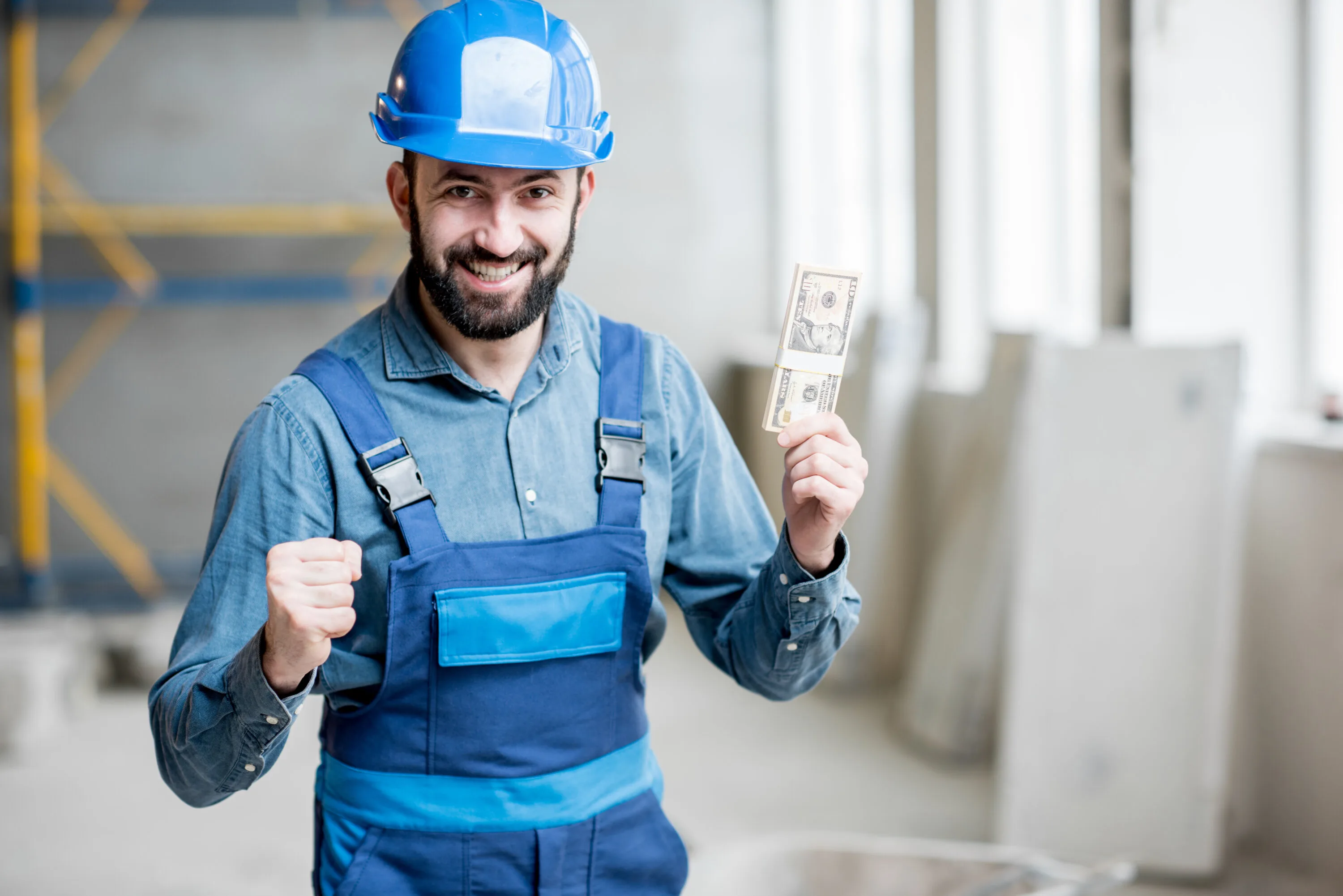 Builder with salary at the construction site